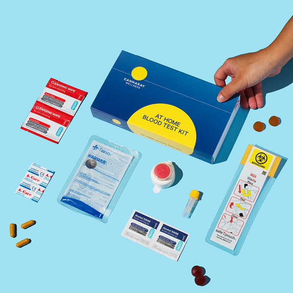 At-home blood test kit with various components on a blue background